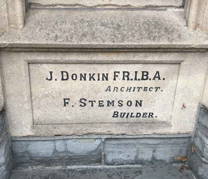 Stone dedication to architect and builder.