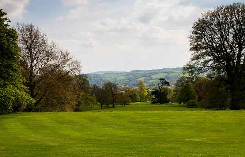 Woodland and countryside over the lawns.