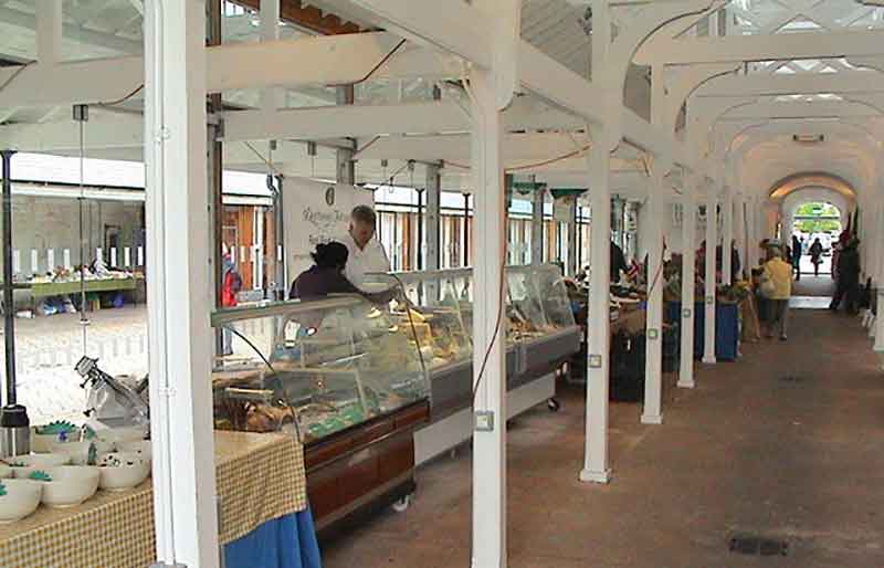 Stalls, shoppers and the internal wood-built structure.